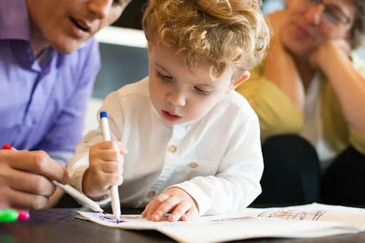 Early education child learning to write with family support